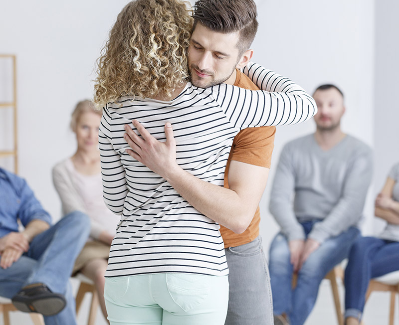 two people Hugging during support group