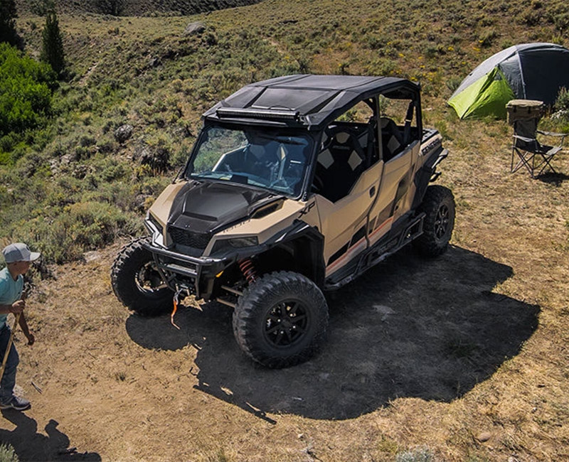 Polaris® GENERAL vehicle driving on tough terrain