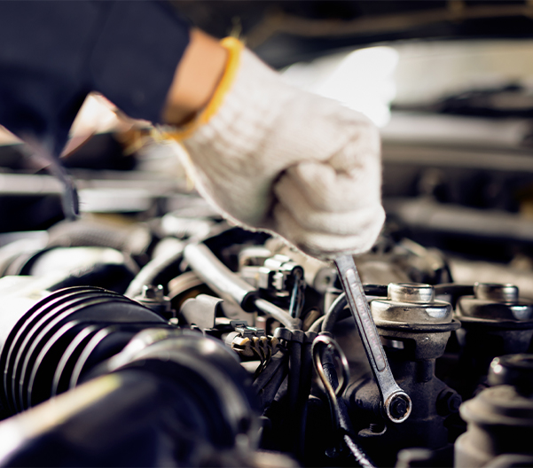 Service mechanic tuning up a vehicle