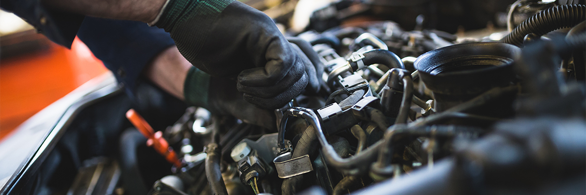 Close up of service tech fixing an engine